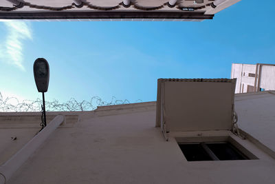 Low angle view of road sign against sky