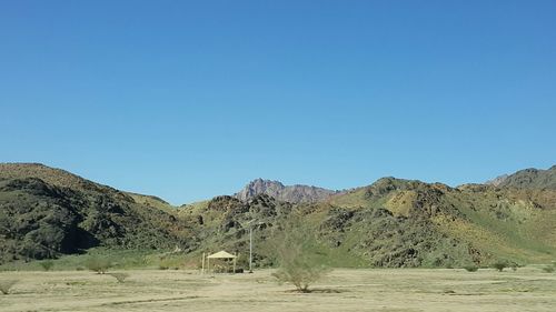 Scenic view of mountains against clear blue sky