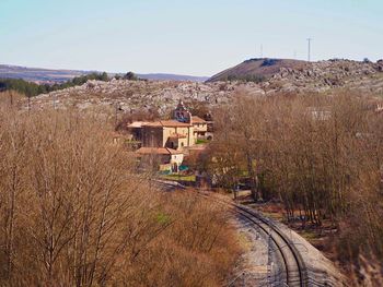 Panoramic view of railroad tracks on field against sky