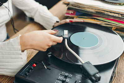 Woman playing music from vinyl record. analog record. retro and vintage style. analog sound. music