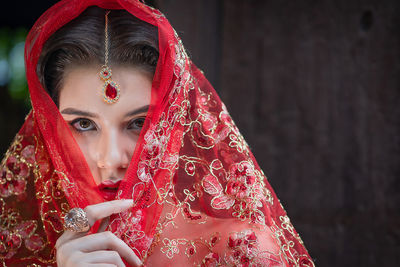 Portrait of woman holding red umbrella