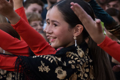 People looking away while dancing during festival