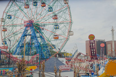 Low angle view of ferris wheel against sky