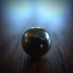 Close-up of light bulb on table