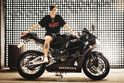 Full length portrait of young man sitting on bicycle