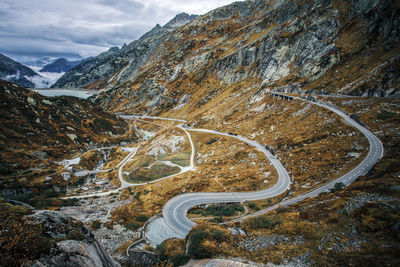 Aerial view of mountain road against cloudy sky