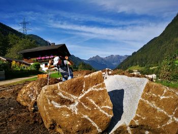 Scenic view of field by mountains against sky