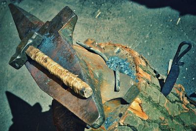 High angle view of hammer on anvil at workshop