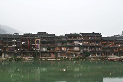 Buildings in town against clear sky