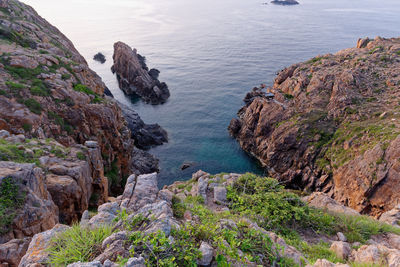 High angle view of rocks on sea shore