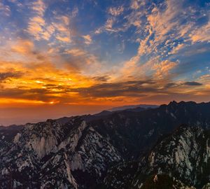 Scenic view of mountains against cloudy sky