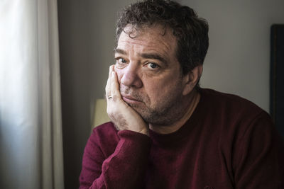 Portrait of mature man sitting at home