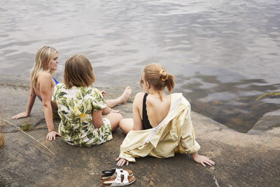 Group of friends resting at lakeside