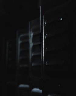 Close-up of empty chairs in the dark