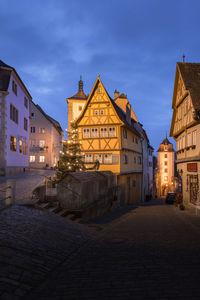 Street amidst buildings in town at night