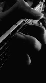 Close-up of man playing guitar