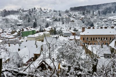 High angle view of snow covered houses in city