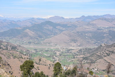 High angle view of valley and mountains against sky