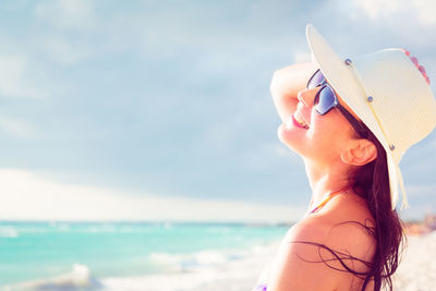 Close-up of woman standing against sea