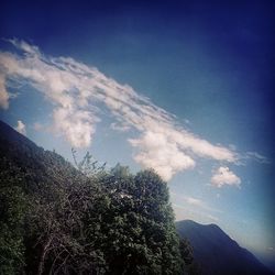 Scenic view of mountains against cloudy sky