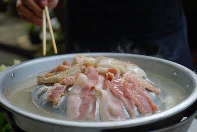 Close-up of person preparing food in bowl