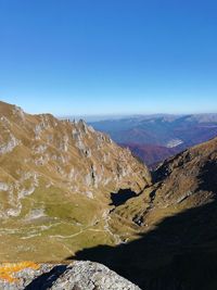 Scenic view of mountains against clear blue sky