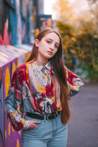 Portrait of beautiful young woman standing in city