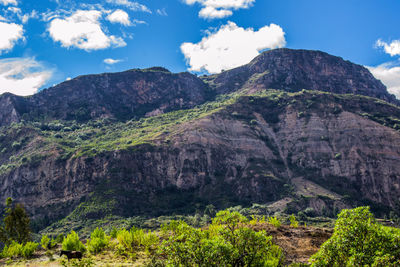 Scenic view of mountains against cloudy sky