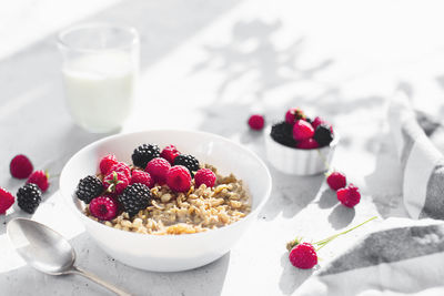 Fruits in plate with glass of table