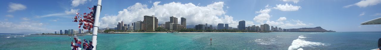 Panoramic view of sea and buildings against sky