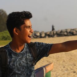 Close-up of young man standing on beach