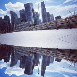 Low angle view of buildings against cloudy sky