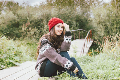 Portrait of smiling woman sitting in park