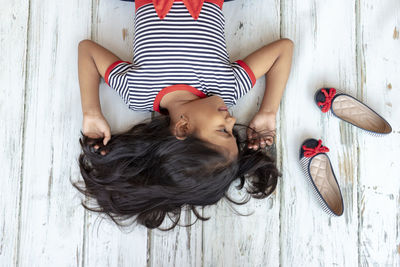 High angle portrait of woman lying on floor