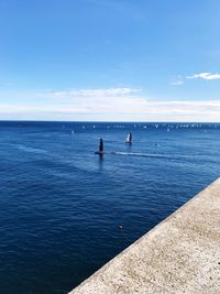 Scenic view of sea against blue sky