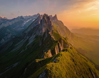 Scenic view of mountains against sky during sunset