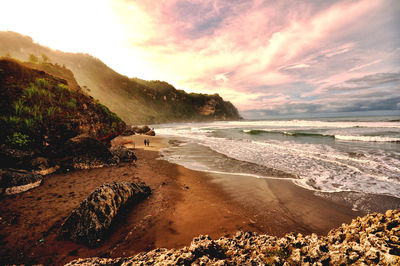 Scenic view of beach against sky during sunset