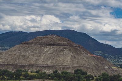 Scenic view of mountain against cloudy sky