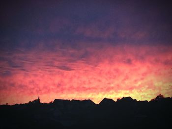 Silhouette of trees against dramatic sky