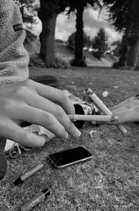 Midsection of man and woman smoking 