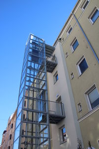 Low angle view of buildings against clear blue sky