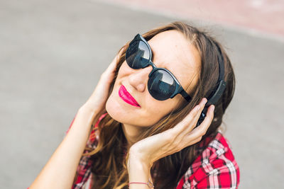 Close-up of woman listening music outdoors