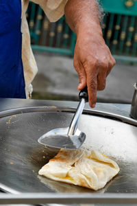 Midsection of man preparing food