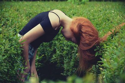 Full length of young woman in grass