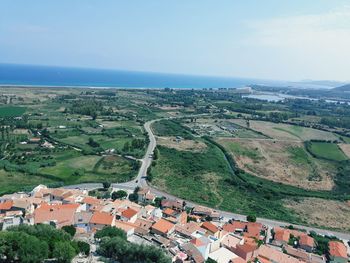 High angle view of townscape by sea against sky