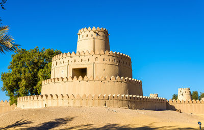 Low angle view of historical building against blue sky