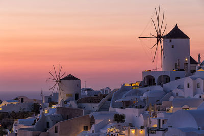 Traditional windmill in city at sunset