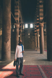 Rear view of man standing in building