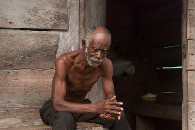 Young man sitting on wall