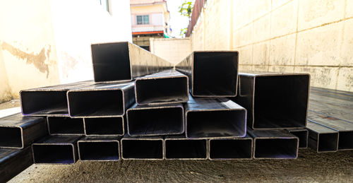 Stack of chairs on table against building